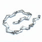 Silver foot-shaped bracelet on a light gray background